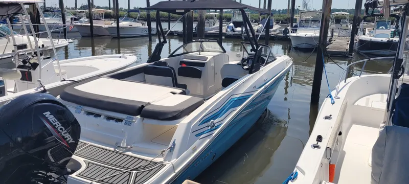 Slide: The Image of 2020 Bayliner VR5 Bowrider OB docked in a marina, featuring sleek design and Mercury outboard engine. - 15
