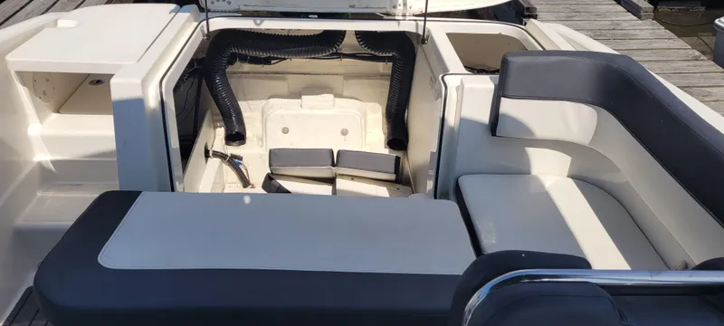 Slide: The Image of 2020 Bayliner VR5 Bowrider OB interior with open engine compartment and seating area. - 25