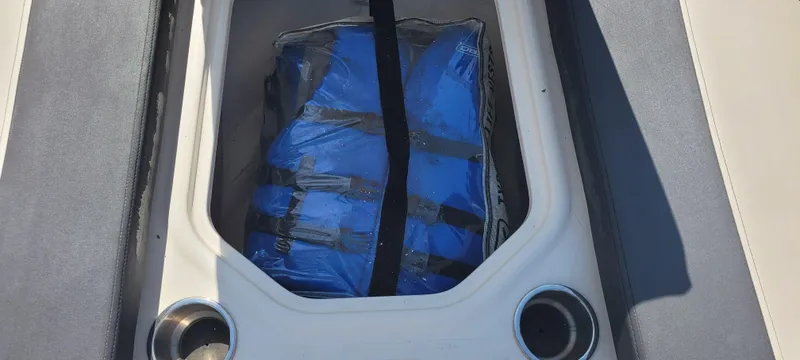 Slide: The Image of Storage compartment with blue life jacket on 2020 Bayliner VR5 Bowrider OB boat. - 27