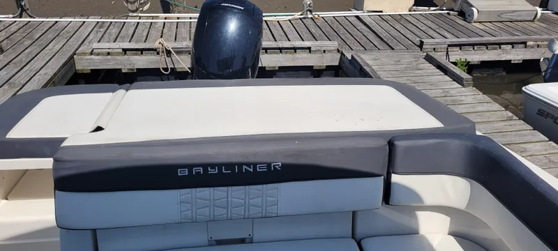 Slide: The Image of 2020 Bayliner VR5 Bowrider OB at dock, showcasing rear seating and engine. - 28