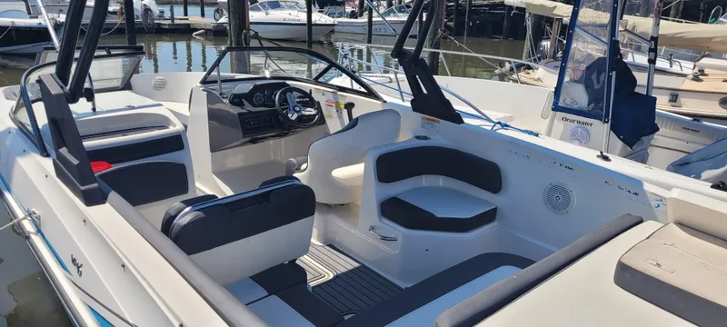 Slide: The Image of 2020 Bayliner VR5 Bowrider OB interior with seating and steering wheel, docked at marina. - 39