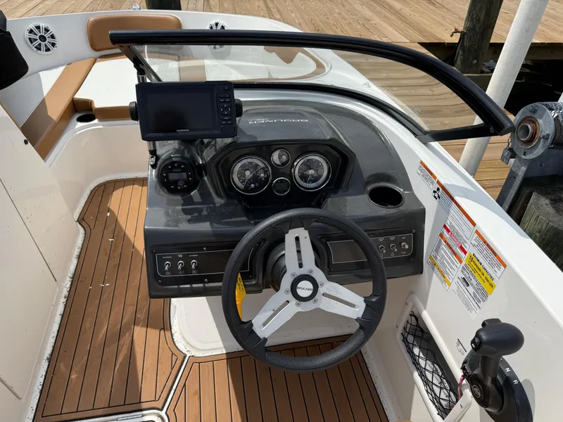 Slide: The Image of 2021 Bayliner VR6 Bowrider OB dashboard with steering wheel and navigation system. - 22