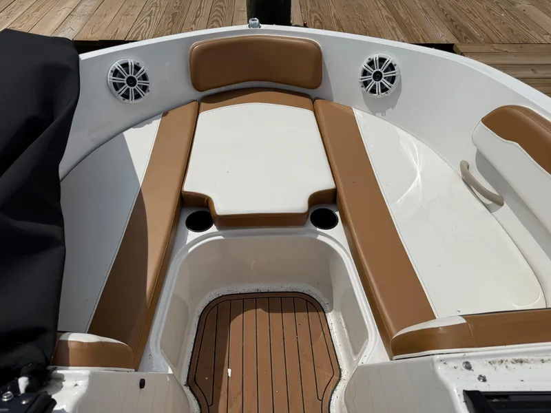 Slide: The Image of 2021 Bayliner VR6 Bowrider OB interior with tan seating and speakers. - 23