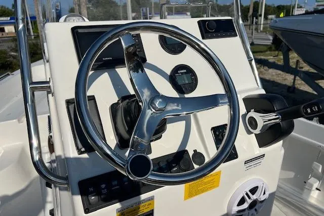 Slide: The Image of 2026 Key West 1720 Center Console boat dashboard with steering wheel and controls. - 2