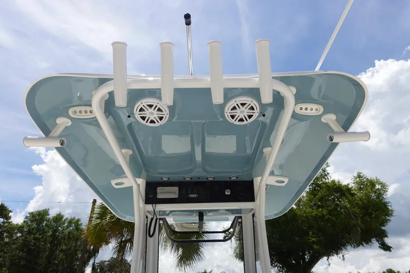 Slide: The Image of 2026 Sea Hunt Ultra 235 SE boat top view with rod holders and speakers against blue sky. - 14