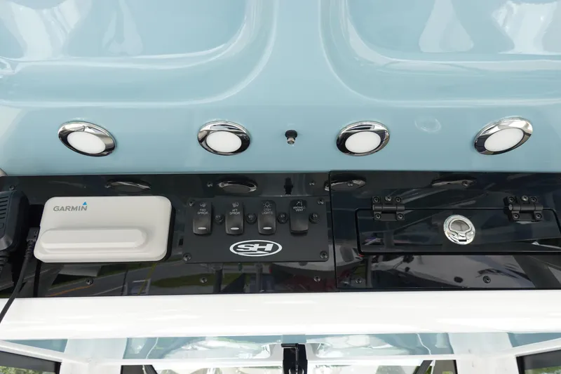 Slide: The Image of 2026 Sea Hunt Ultra 235 SE dashboard with Garmin device and control panel. - 24