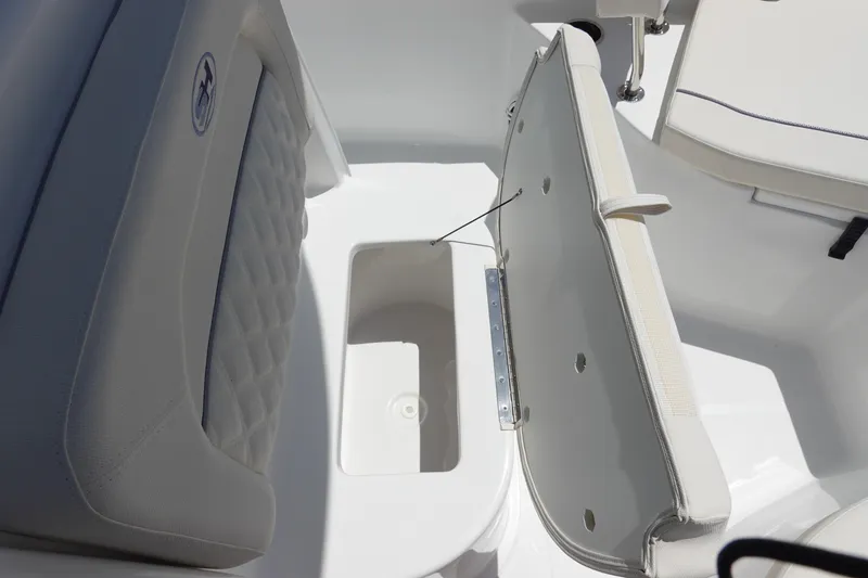 Slide: The Image of 2026 Sea Hunt Ultra 235 SE boat seat with storage compartment open. - 27