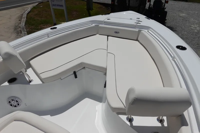 Slide: The Image of 2026 Sea Hunt Ultra 235 SE boat with spacious white seating area. - 28