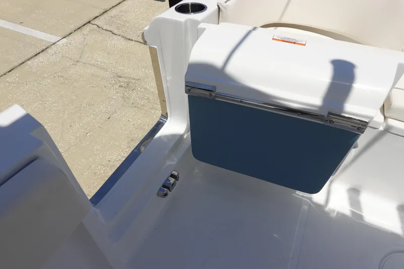 Slide: The Image of 2026 Sea Hunt Ultra 235 SE boat interior with cooler and seating area. - 36