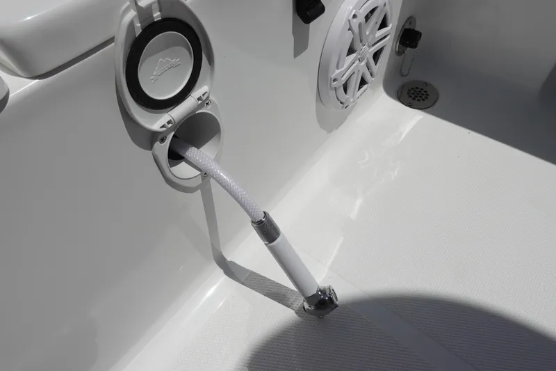 Slide: The Image of 2026 Sea Hunt Ultra 235 SE boat deck with hose and speaker detail. - 39