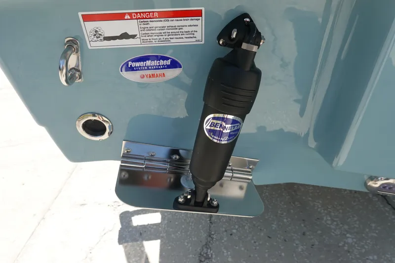 Slide: The Image of Trim tab and warning label on 2026 Sea Hunt Ultra 235 SE boat. - 40