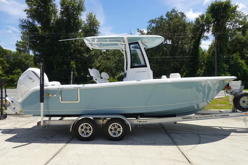 Slide: The Image of 2026 Sea Hunt Ultra 235 SE boat on trailer, side view, outdoors. - 5