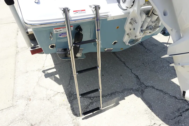 Slide: The Image of Rear view of 2026 Sea Hunt Ultra 235 SE boat with ladder extended. - 7