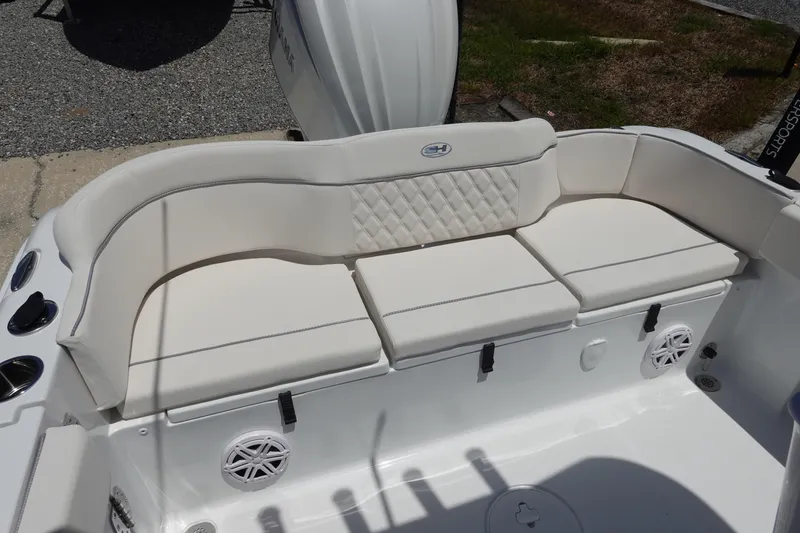 Slide: The Image of 2026 Sea Hunt Ultra 235 SE boat with white cushioned seating and speaker system. - 8