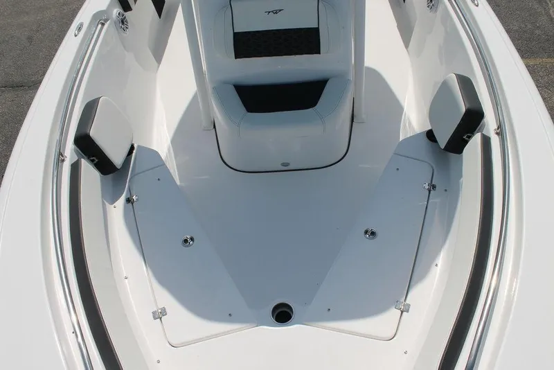 Slide: The Image of 2025 Tidewater 210 CC Adventure boat interior, featuring seating and storage compartments. - 16