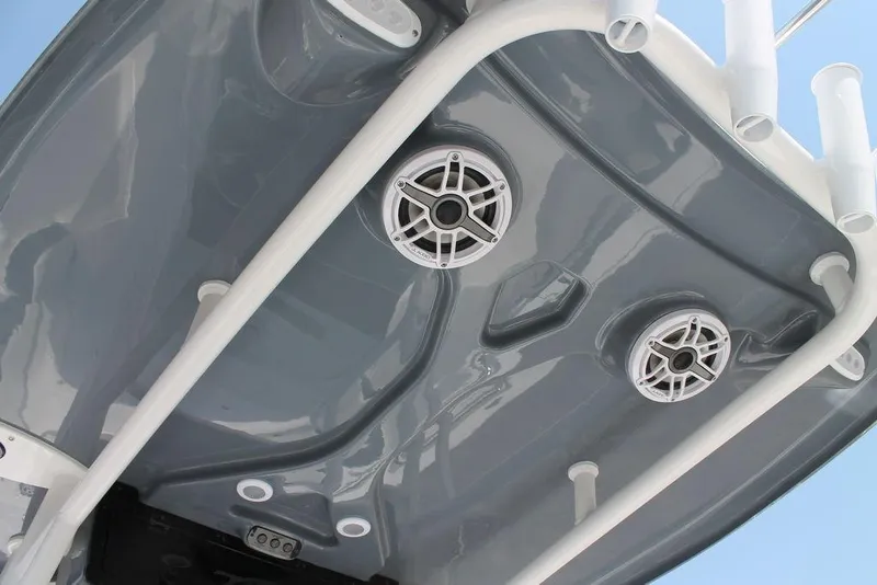 Slide: The Image of 2025 Tidewater 210 CC Adventure boat speakers and rod holders on a sleek gray surface. - 17