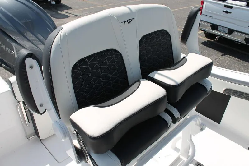 Slide: The Image of 2025 Tidewater 210 CC Adventure boat seats with black and white cushioned design. - 3