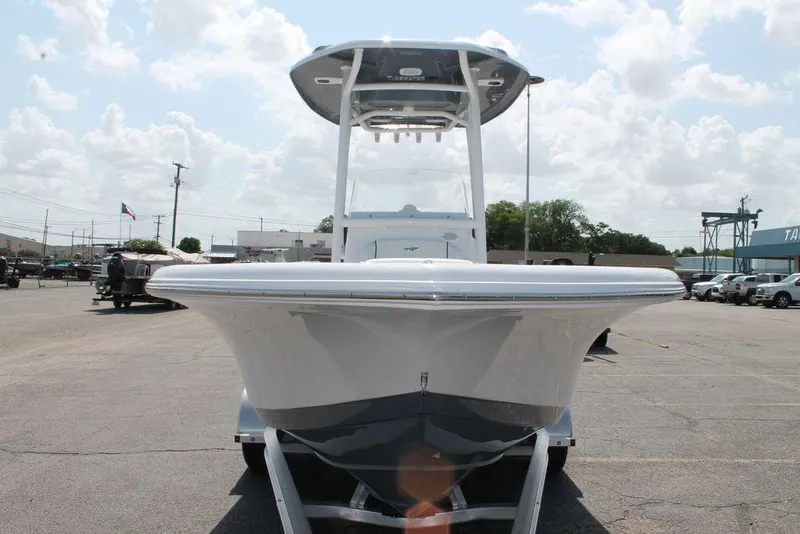 Slide: The Image of 2025 Tidewater 210 CC Adventure boat on trailer, parked outdoors under cloudy sky. - 7