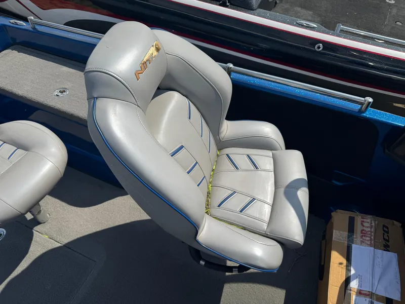 Slide: The Image of Nitro ZV21 2018 boat seat, gray with blue accents, on deck. - 10