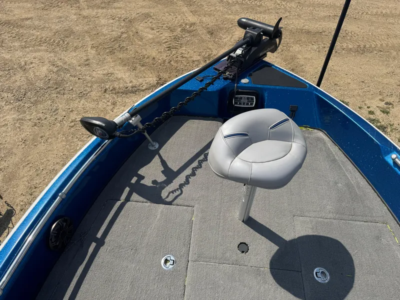 Slide: The Image of 2018 Nitro ZV21 boat deck with seat and trolling motor, on sandy terrain. - 12