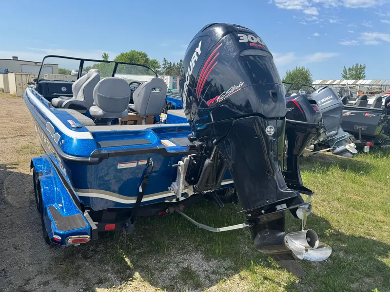 Slide: The Image of Blue 2018 Nitro ZV21 boat with Mercury 300 Pro outboard motor, parked outdoors. - 5