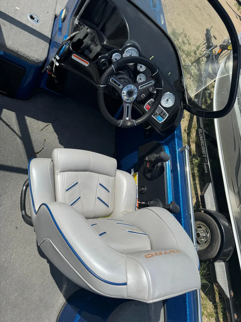 Slide: The Image of Interior of a 2018 Nitro ZV21 boat featuring steering wheel and cushioned seat. - 7