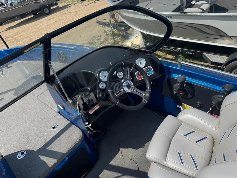 Slide: The Image of 2018 Nitro ZV21 boat cockpit with steering wheel and controls. - 8