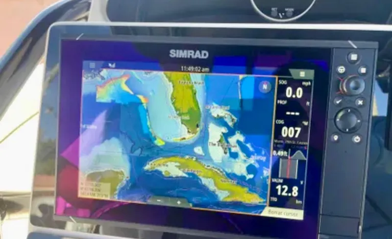 Slide: The Image of Simrad navigation display on 2006 Wellcraft 32 CCF boat, showing nautical map and data. - 26