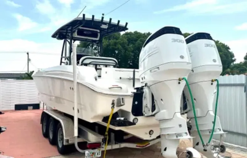 Slide: The Image of 2006 Wellcraft 32 CCF boat on trailer with dual outboard engines. - 3