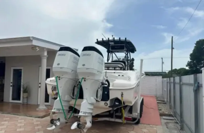 Slide: The Image of 2006 Wellcraft 32 CCF boat with dual engines parked in a driveway. - 42