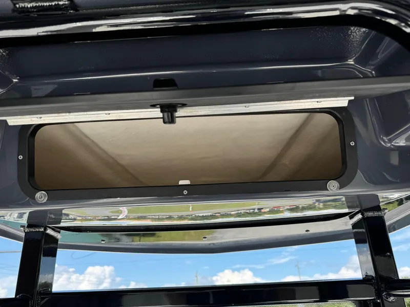 Slide: The Image of 2025 Robalo R246 CAYMAN boat storage compartment, open hatch view. - 12