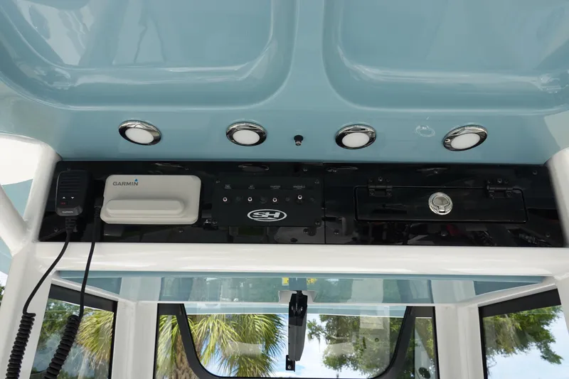 Slide: The Image of 2026 Sea Hunt Gamefish 25 console with Garmin electronics and overhead lighting. - 16