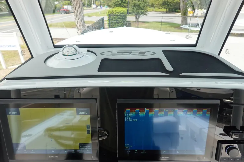 Slide: The Image of 2026 Sea Hunt Gamefish 25 dashboard with Garmin displays and compass. - 17