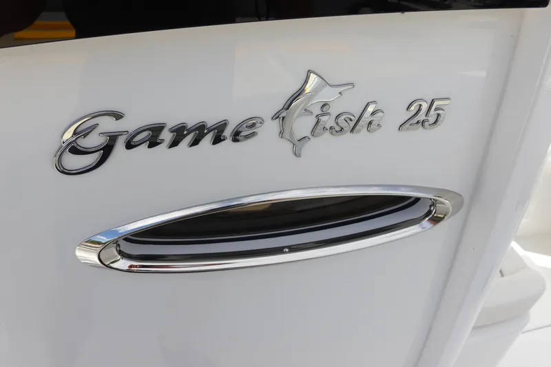 Slide: The Image of 2026 Sea Hunt Gamefish 25 boat logo on white surface. - 20