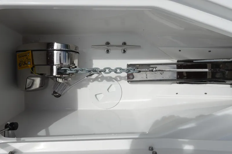 Slide: The Image of Anchor compartment of 2026 Sea Hunt Gamefish 25 boat, featuring chain and winch system. - 33