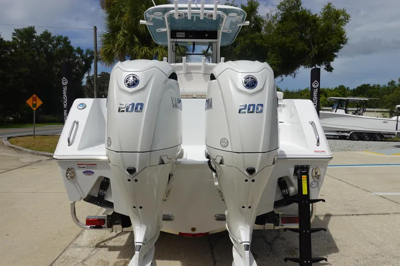 Slide: The Image of 2026 Sea Hunt Gamefish 25 with dual Yamaha 200 engines, parked outdoors. - 6