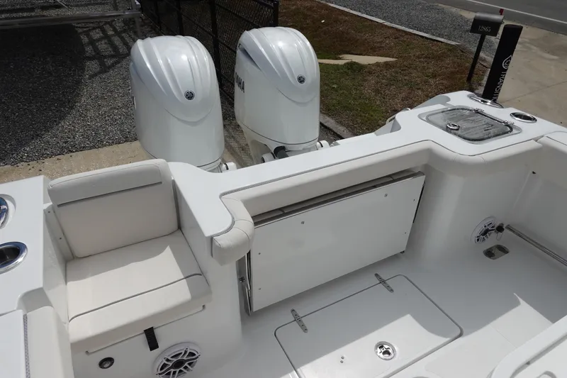 Slide: The Image of 2026 Sea Hunt Gamefish 25 boat with dual Yamaha engines and spacious seating area. - 7