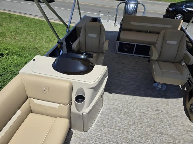 Slide: The Image of 2025 Godfrey Xperience 2286 SFLX Sport Tube interior with beige seating and helm station. - 10