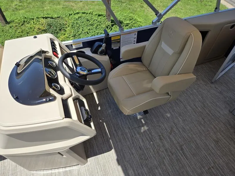 Slide: The Image of 2025 Godfrey Xperience 2286 SFLX boat interior with steering wheel and captain's chair. - 11