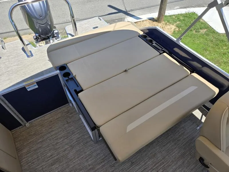 Slide: The Image of 2025 Godfrey Xperience 2286 SFLX boat with beige seating and cup holders. - 14