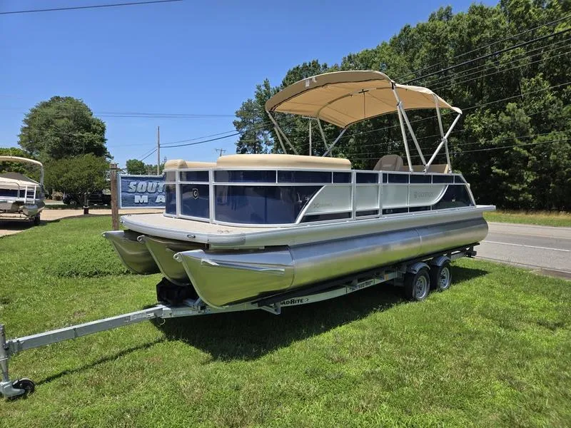 Slide: The Image of 2025 Godfrey Xperience 2286 SFLX pontoon boat on trailer, parked on grass. - 3