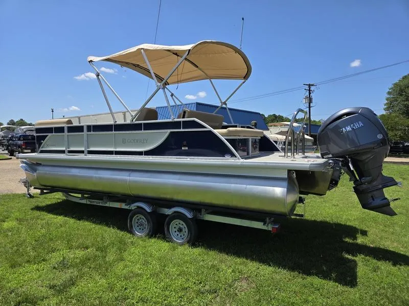 Slide: The Image of 2025 Godfrey Xperience 2286 SFLX pontoon boat with Yamaha motor on trailer, sunny day. - 6