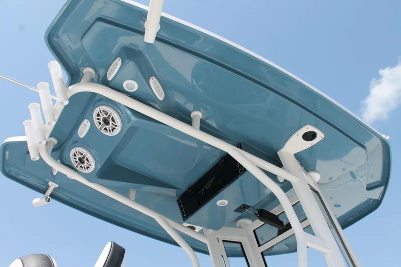 Slide: The Image of 2025 Tidewater 2500 CB boat's blue T-top with speakers and rod holders. - 14