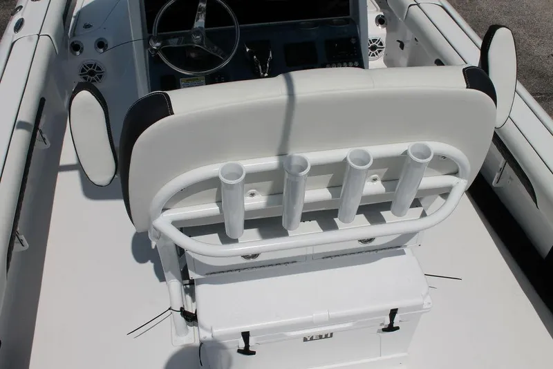 Slide: The Image of 2025 Tidewater 2500 CB boat interior with rod holders and Yeti cooler. - 8