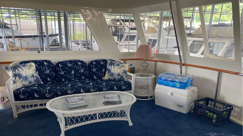 Slide: The Image of Interior of 1987 Hatteras 58 Motor Yacht with cozy seating and nautical decor. - 14