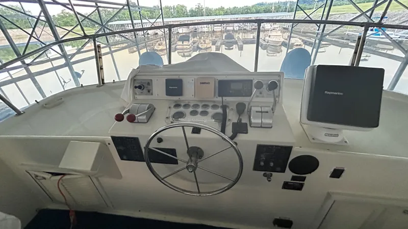 Slide: The Image of 1987 Hatteras 58 Motor Yacht helm with steering wheel and navigation equipment. - 16