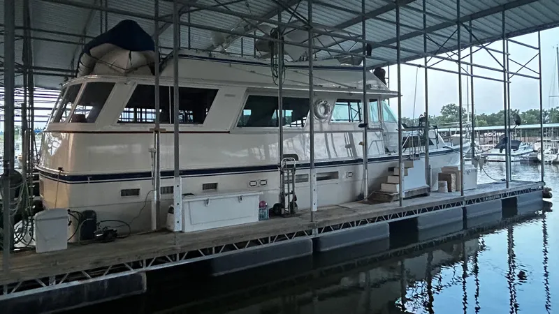Slide: The Image of 1987 Hatteras 58 Motor Yacht docked in a covered marina. - 18