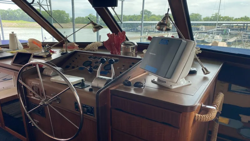 Slide: The Image of 1987 Hatteras 58 Motor Yacht helm with steering wheel, controls, and navigation equipment. - 5