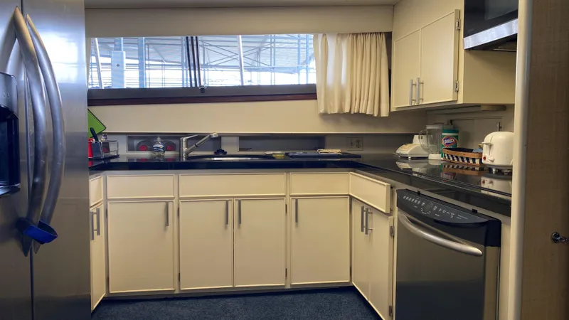 Slide: The Image of 1987 Hatteras 58 Motor Yacht kitchen with modern appliances and sleek cabinetry. - 6