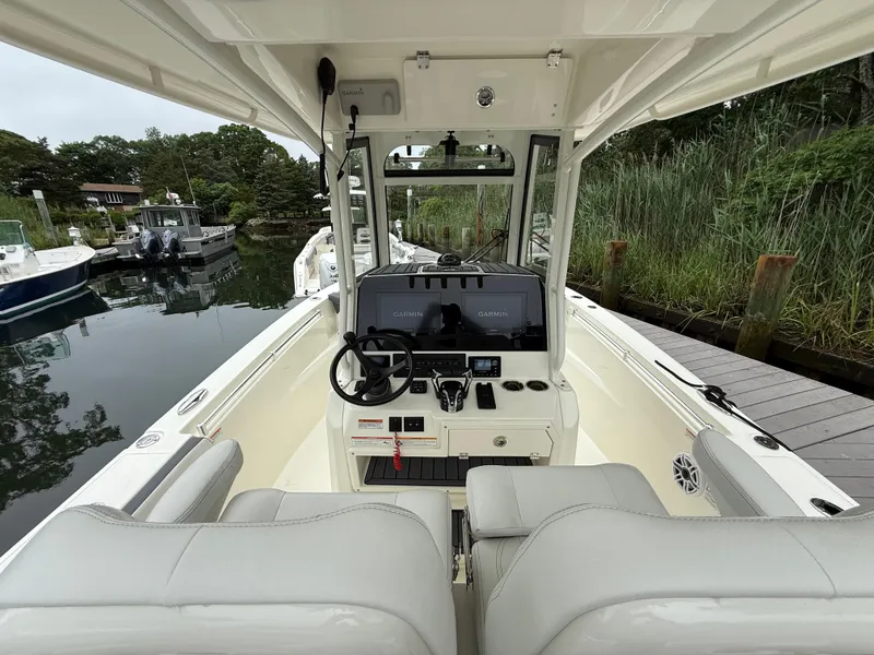 Slide: The Image of 2025 Cobia 265 Open Center Console boat interior with Garmin navigation system. - 12